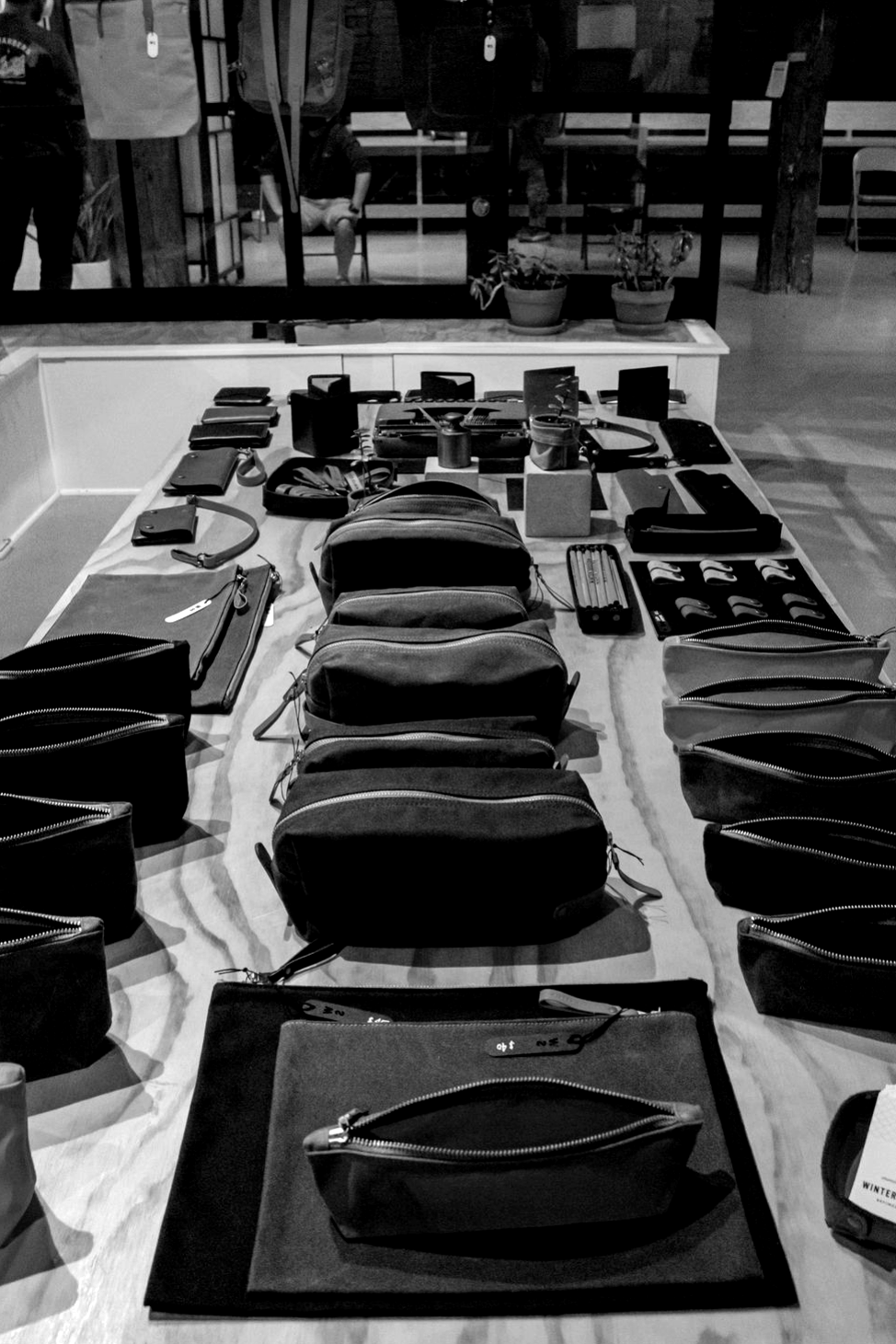 black and brown leather bag on brown wooden table
